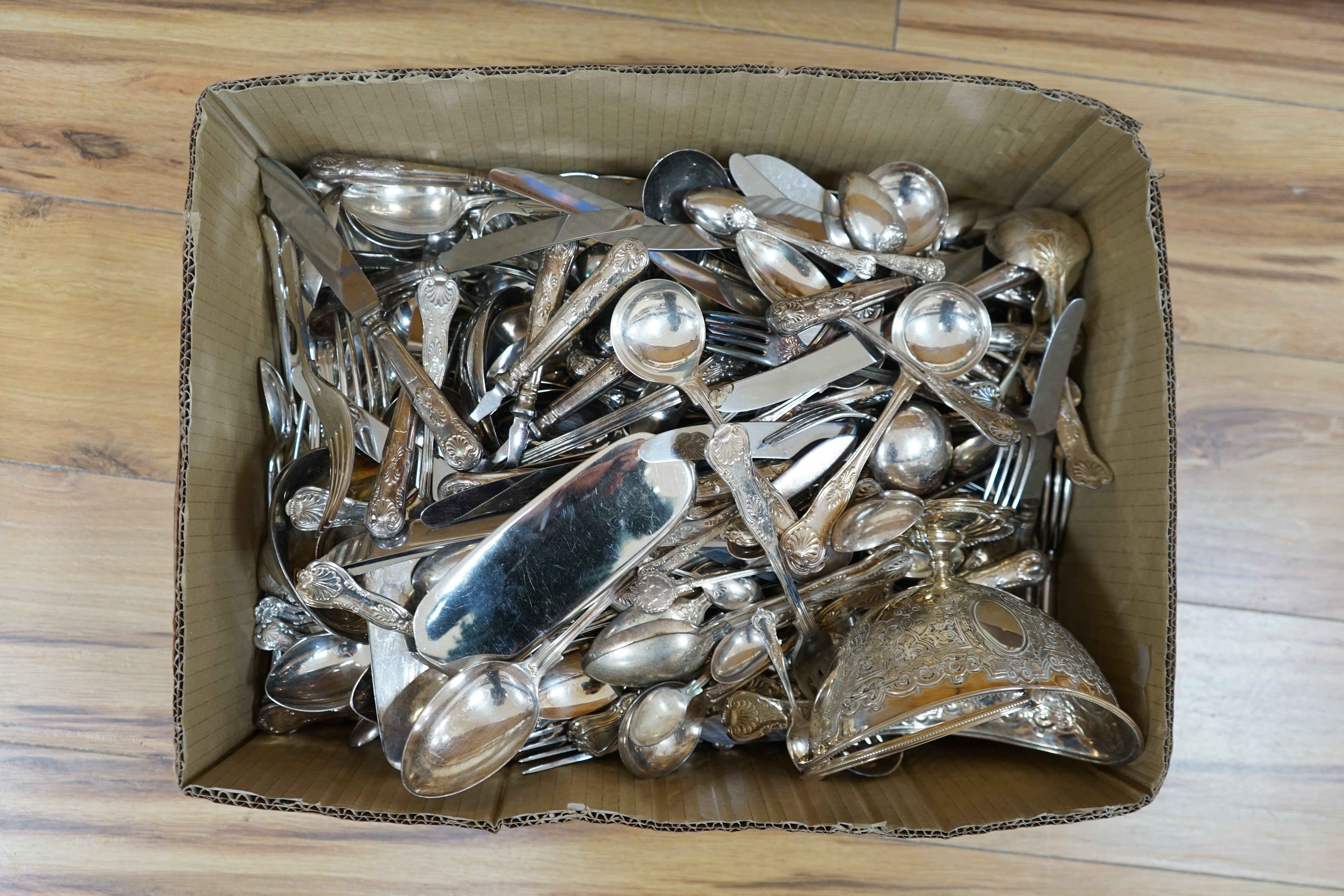 A large quantity silver plated cutlery including a part canteen of King's pattern cutlery and beaded pattern cutlery, a plated sugar basket, together with a mahogany, velvet lined box, 38cm wide. Condition - fair